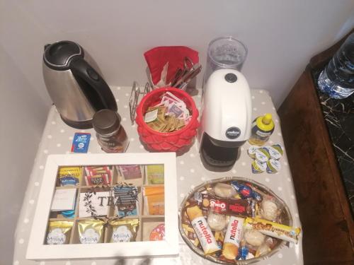 a table with food and other items on it at Battisti 18 Vintage Rooms in Palermo