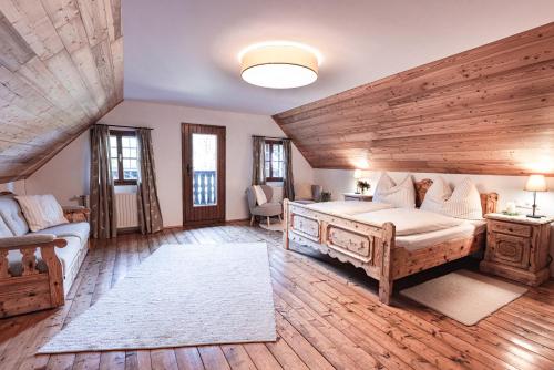 a large bedroom with a large bed and a couch at Winzerhaus am Schöckl in Semriach