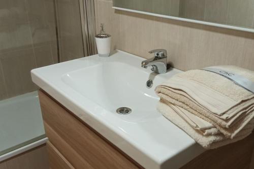 biała umywalka z ręcznikiem w obiekcie Ático en Paiporta con 2 grandes terrazas w Walencji