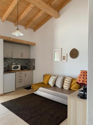 a living room with a couch and a kitchen at Herdade Da Maridona - Agroturismo in Estremoz