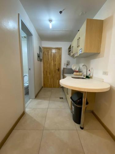 a kitchen with a counter and a sink in a room at CedarPeak213b in Baguio