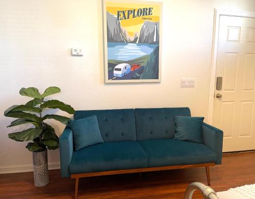 a blue couch in a living room with a painting at Casita Alkie in Litchfield Park
