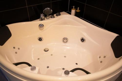 a white bath tub with a face painted on it at Dépendance chaleureuse et calme in Champagneux