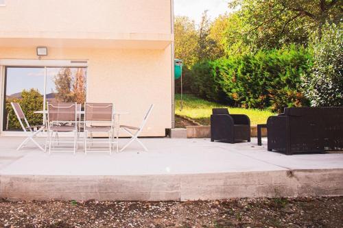 a table and chairs sitting outside of a building at Dépendance chaleureuse et calme in Champagneux