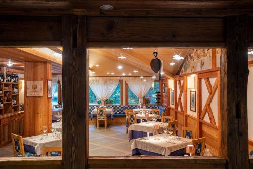 un restaurante con mesas y sillas en una habitación en Hotel Lo Scoiattolo, en Gressoney-la-Trinité