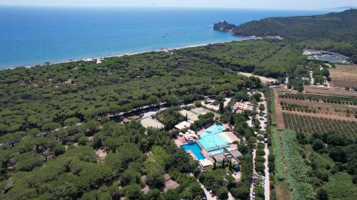 an aerial view of a resort with a pool and the ocean at Camping Village Rocchette in Castiglione della Pescaia