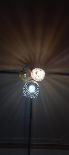 a light hanging from a ceiling in a room at Du Gia View Homestay in Làng Cac