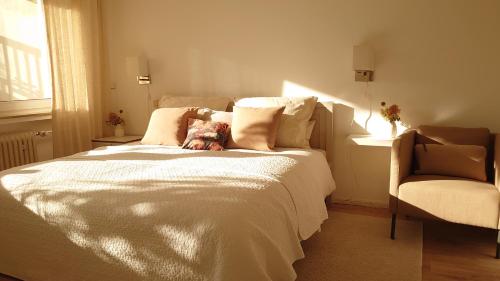 a dog laying on a bed in a bedroom at Ferien am See in Möhnesee