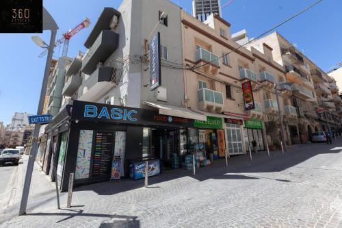a street corner with a building with a bike store at Spacious PV Apt close to clubs & schools with WIFI by 360 Estates in Paceville