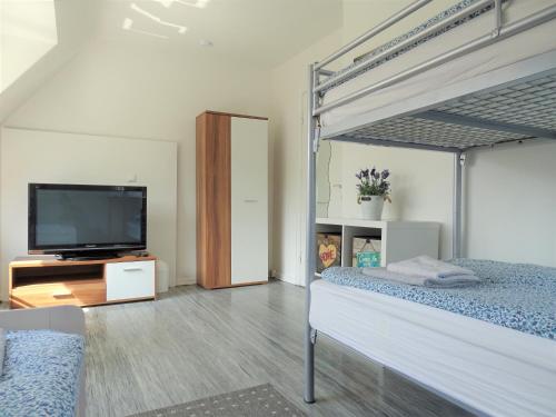 a bedroom with a bed and a flat screen tv at The Old Doctors Office in Hamburg