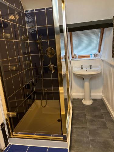 a bathroom with a shower and a sink at Lulus in St Bees