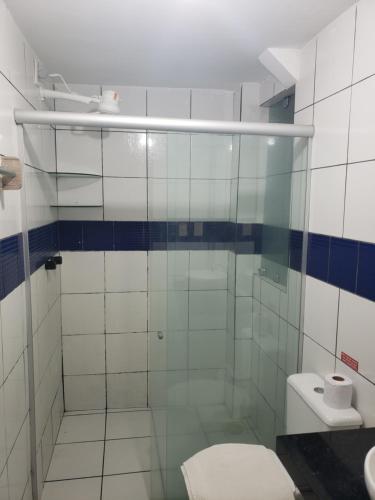 a bathroom with a glass shower with a toilet at Pousada Dragao Do Mar in Fortaleza
