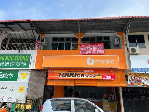 an orange building with signs on the side of it at Homestay Malim Nawar in Malim Nawar