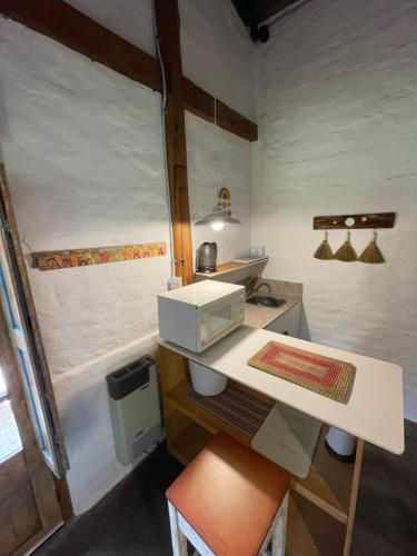 a small kitchen with a white counter in a room at ocre y madera in Ciudad Lujan de Cuyo