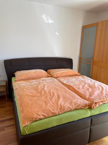 a bed with two pillows on it in a room at Appartement 4You in Schladming