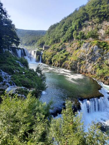 a river with waterfalls in the middle of a mountain at Seosko domacinstvo Halil & Alema in Ćukovi