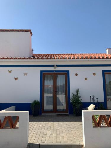 a blue and white house with a door at Herdade Da Maridona - Agroturismo in Estremoz