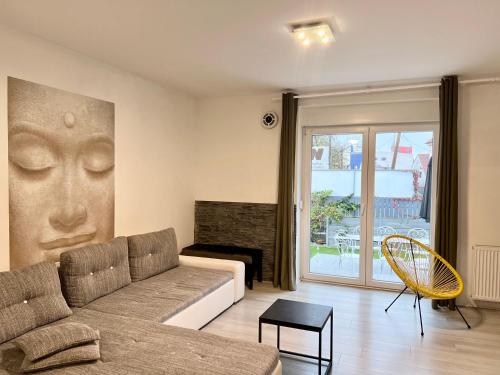 a living room with a couch and a fireplace at LTE Apartments in Maribor