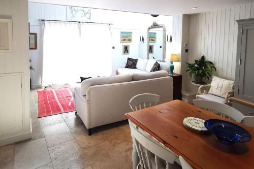 a living room with a couch and a table at Lovely 2 bed annexe near Salisbury in Salisbury