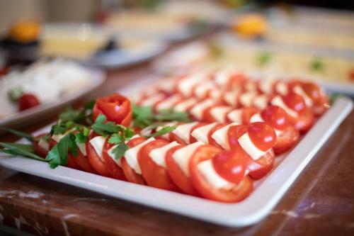 a plate of hot dogs with ketchup and tomatoes at Altstadthotel Messerschmitt in Bamberg