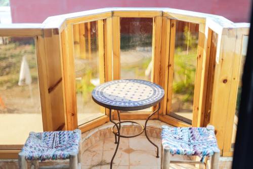 a small table and two chairs in a house at Chillax room salon 2P in Agadir