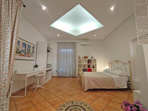 a bedroom with a bed and a desk in it at Sole Luna Mare in Pozzuoli