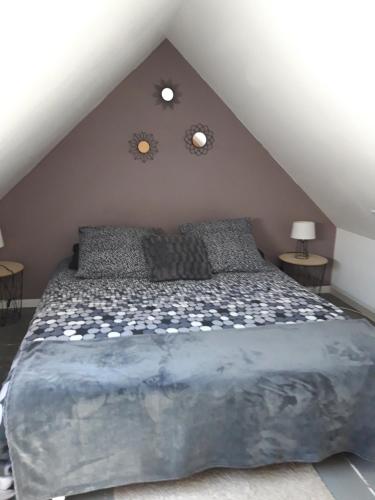 a bedroom with a large bed in a attic at Les Apparts' Hotel du Canal in Châteaulin