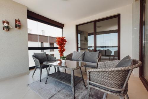 a living room with a table and chairs at Armoni Deluxe Suites Trabzon in Trabzon