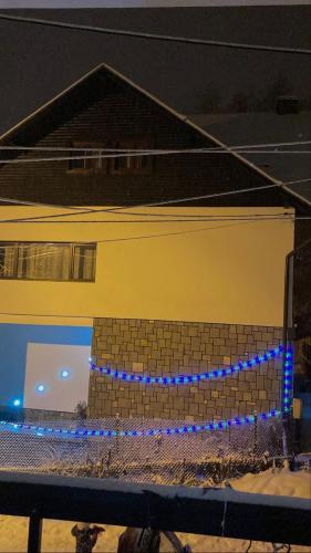 a building with blue lights on the side of it at Residence SINAIA Apartments in Sinaia