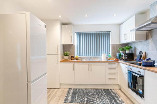 a kitchen with white appliances and a window at Sounds of Stars in Mansfield