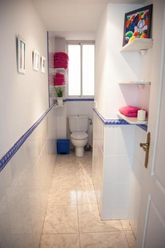 a white bathroom with a toilet and a window at SEAFRONT UNBEATABLE LOCATION a in Benidorm