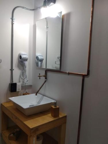 a bathroom with a sink and a mirror at Santa Teresita Loft in Cali