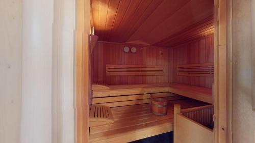 an empty sauna with wooden walls and wooden floors at Truoch in Samedan