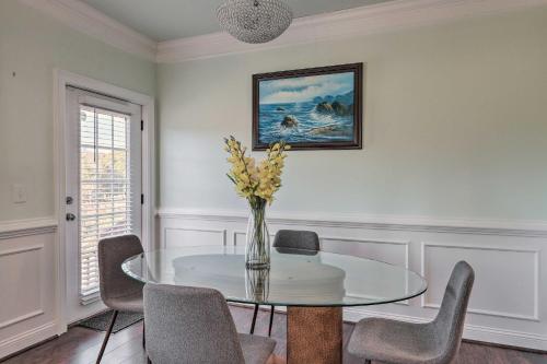 a dining room with a table with chairs and a vase of flowers at Jackson Getaway and Yard, 4 Mi to High Falls SP in Jackson
