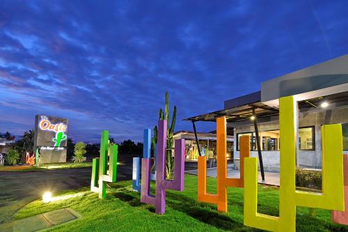 a group of colorful sculptures in front of a building at The Oasis Resort in Krabi