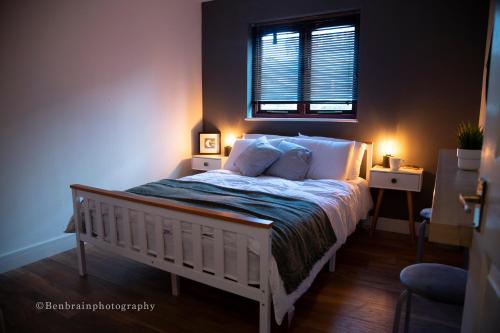 a bedroom with a bed with a window and lights at No31 Apartment Cardiff in Cardiff