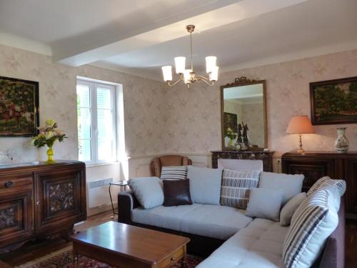 a living room with a couch and a table at Charmante maison rénovée avec jardin clos, 3 chambres, proche sites touristiques et villlage médiéval - FR-1-489-105 in Saint-Bonnet-de-Rochefort