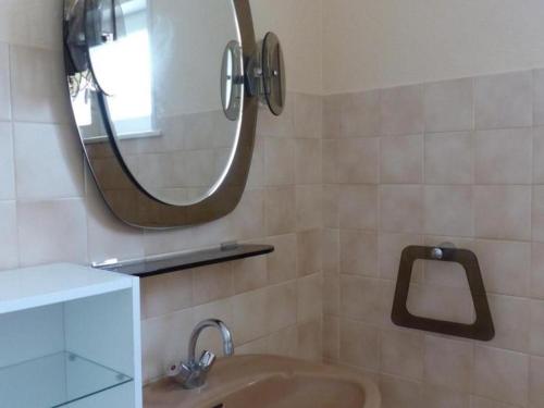 a bathroom with a sink and a mirror at Charmante maison rénovée avec jardin clos, 3 chambres, proche sites touristiques et villlage médiéval - FR-1-489-105 in Saint-Bonnet-de-Rochefort