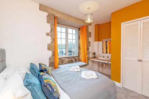 a living room with a couch and a window at Bridge End Mill by Guestz in Settle