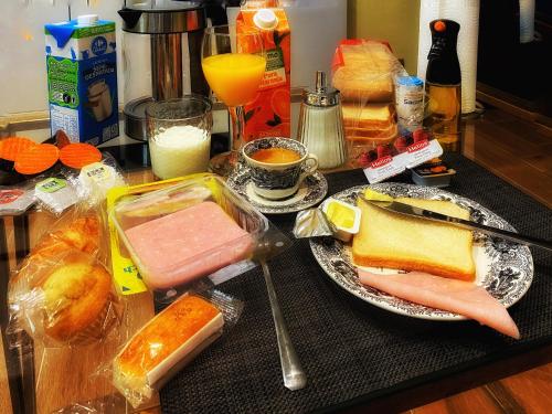 a table topped with plates of food and drinks at SUITES SAN ESTEBAN 16 Principe in Seville