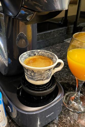 a cup of coffee and a glass of orange juice at SUITES SAN ESTEBAN 16 Principe in Seville