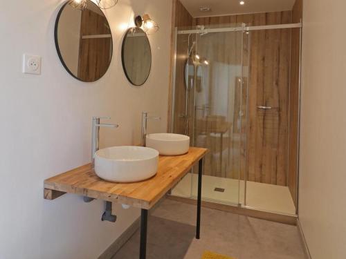 a bathroom with two sinks and a shower at Gîte Sap-en-Auge, 4 pièces, 5 personnes - FR-1-497-146 in Le Sap