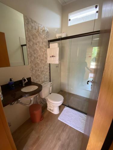 a bathroom with a toilet and a sink and a shower at Amanduarte Brasília in Brasilia