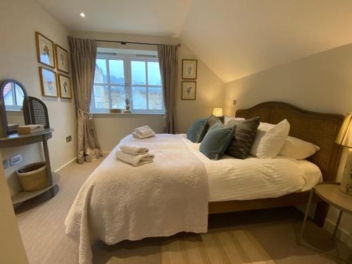 a bedroom with a large bed with towels on it at Walcot Yard, Bath in Bath
