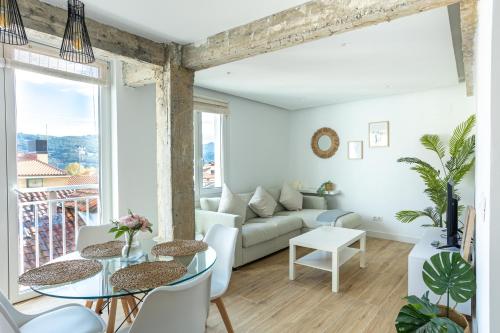 a living room with a couch and a table at Mundaka Centre by Urdaibai Rentals in Mundaka