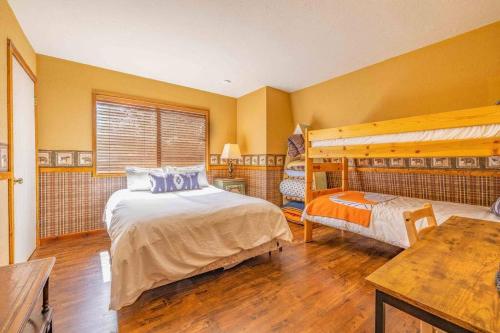 a bedroom with a large bed and a desk at Amazing Cabin - Close To Ski Resort and Village in Big Bear Lake