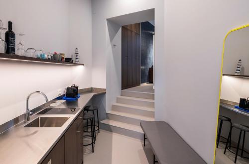 a kitchen with stairs leading up to a stair case at grätzlhotel Serviten in Vienna