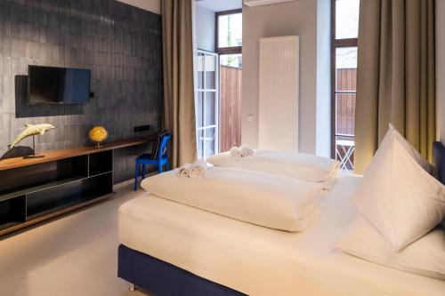 Postel nebo postele na pokoji v ubytování grätzlhotel Serviten