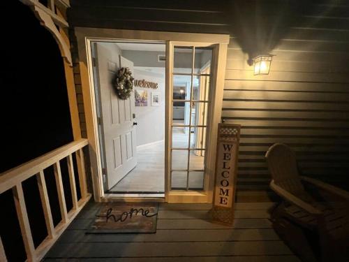 a front door of a house with a welcome sign at Cypress Cove Townhome on Canal in Inverness