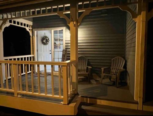 a screened in porch with two chairs on a house at Cypress Cove Townhome on Canal in Inverness